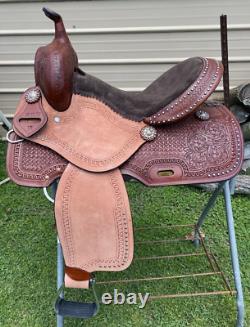 15 silver studded Western barrel saddle withtooled leather, roughout fenders