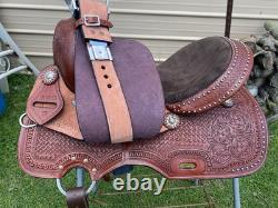 15 silver studded Western barrel saddle withtooled leather, roughout fenders