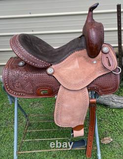15 silver studded Western barrel saddle withtooled leather, roughout fenders