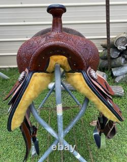 15 silver studded Western barrel saddle withtooled leather, roughout fenders