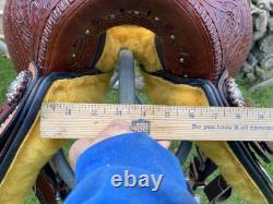 15 silver studded Western barrel saddle withtooled leather, roughout fenders