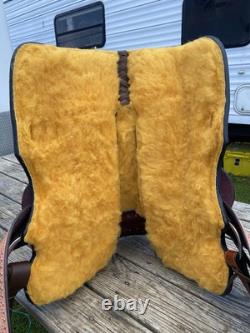 15 silver studded Western barrel saddle withtooled leather, roughout fenders
