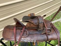 16 Antique A fork Western saddle withsteel horn, leather covered rigging