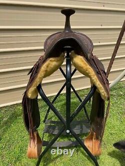 16 Antique A fork Western saddle withsteel horn, leather covered rigging