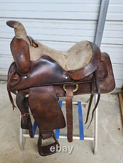 A good Used 15 Brown Color Roping Saddle with some tooling