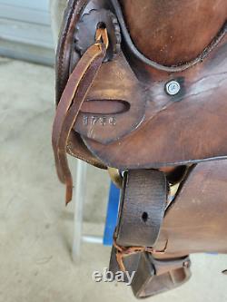 A good Used 15 Brown Color Roping Saddle with some tooling