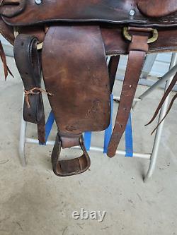 A good Used 15 Brown Color Roping Saddle with some tooling