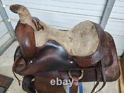 A good Used 15 Brown Color Roping Saddle with some tooling