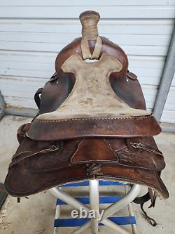 A good Used 15 Brown Color Roping Saddle with some tooling