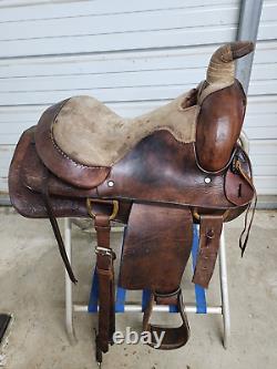 A good Used 15 Brown Color Roping Saddle with some tooling