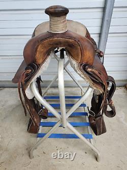 A good Used 15 Brown Color Roping Saddle with some tooling