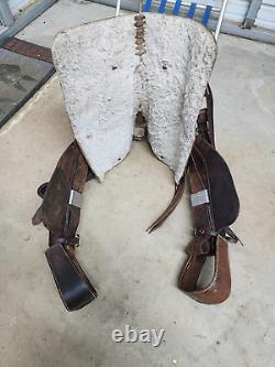 A good Used 15 Brown Color Roping Saddle with some tooling