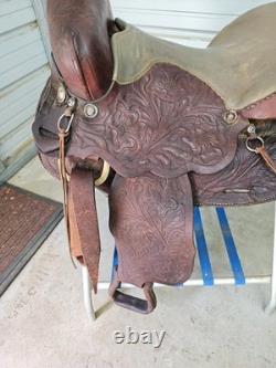 A good Used Brown Color 15 leather Trail saddle with Tooling