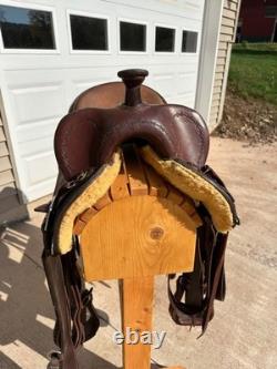 Slightly used 15 inch seat Clinton Anderson roughout western saddle by Martin