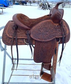 Used 13 brown tooled leather youth/child's western saddle withsuede seat US made