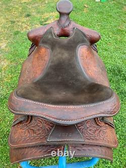 Used 15 Western saddle withtooled horse heads US made