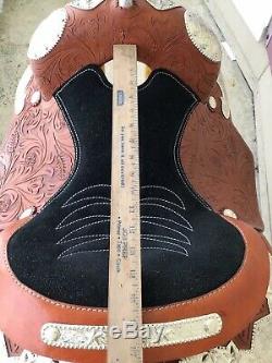 Used 15 western show saddle withsilver, tooled leather, stirrups adjust short