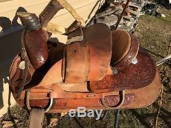 Used 16.5 Santa Fe Western roping saddle withtooled skirts, rough out fenders