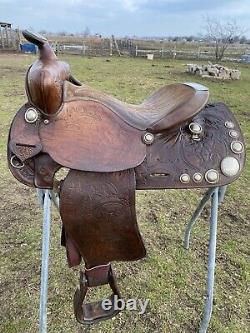 Used/vintage Simco 15 tooled Western saddle withsilver conchos