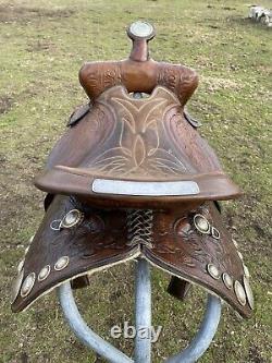 Used/vintage Simco 15 tooled Western saddle withsilver conchos