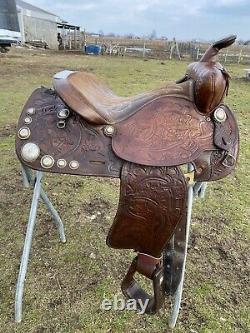 Used/vintage Simco 15 tooled Western saddle withsilver conchos