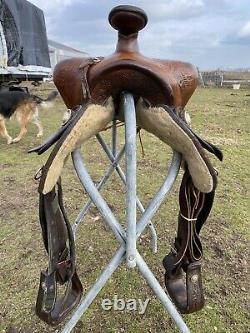 Used/vintage Simco 15 tooled Western saddle withsilver conchos