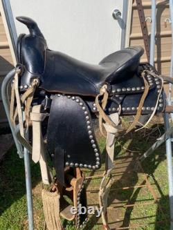 Used/vintage/antique 12 studded leather western pony saddle withwhite strings
